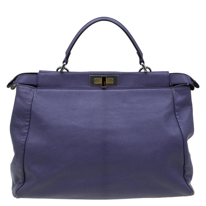 Fendi's iconic 'Peekaboo' tote is represented through this purple supple leather. This roomy Italian-crafted piece has two separate compartments which open with double turnlock top closure and a zipped pocket for stowing cosmetics or keys. It also