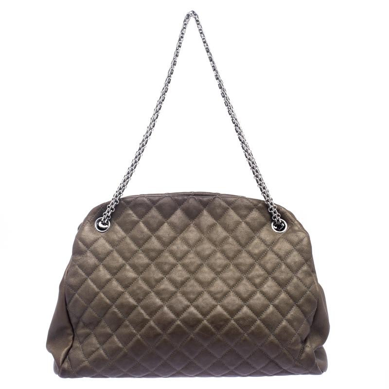 Spacious and captivating, this Just Mademoiselle Bowling bag is from Chanel. It has been crafted from Caviar leather in their signature quilt pattern and accented with silver-tone hardware. It is equipped with two chain handles and a snap button