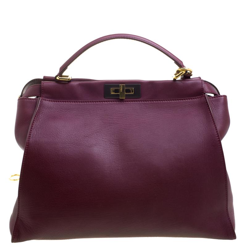Fendi's Peekaboo bag was first introduced in their 2009 spring/summer collection. Crafted from burgundy leather, the bag features a top handle and a shoulder strap for you to use as a crossbody. A turn-lock closure opens to a suede interior that