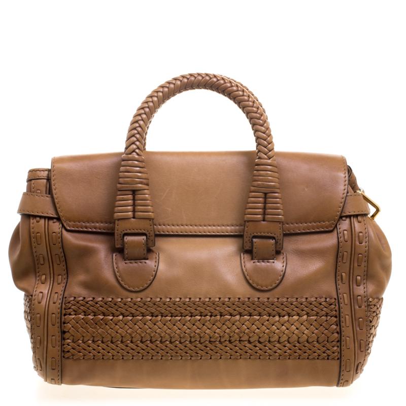 From the legendary house of Gucci, this bag is designed in a brown leather and detailed with tonal stitching. It comes with two top rolled handles and opens to a suede interior fitted with a zip wall pocket. Carry it in the crook of your arm to