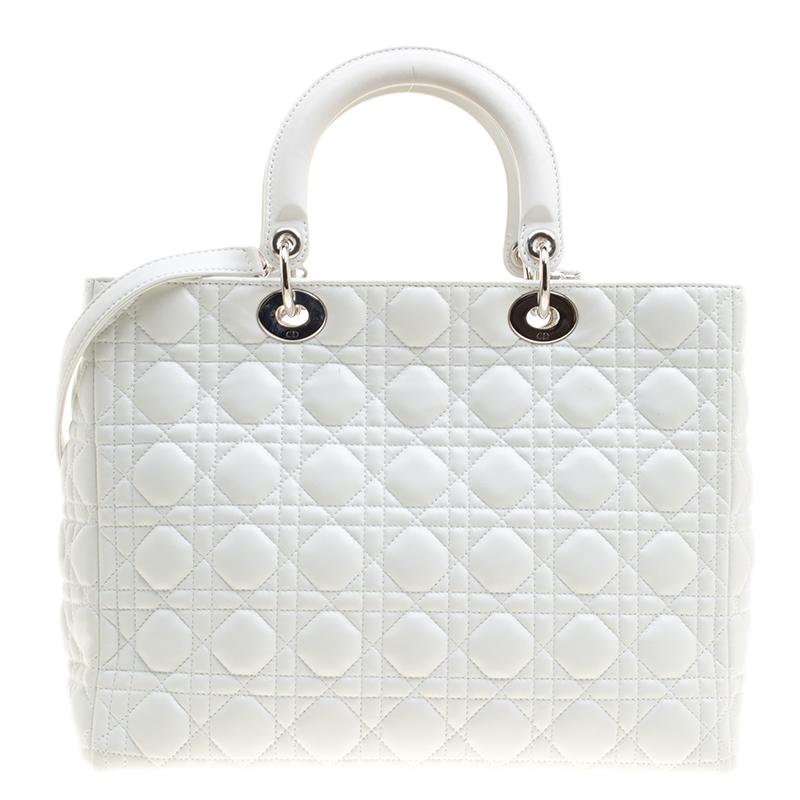 The Lady Dior tote from Dior is remarkable, highly coveted, and since its birth in 1994, it has swayed us with its shape, design, and beauty. This version is a joy to witness! It comes meticulously crafted from white leather and designed with their