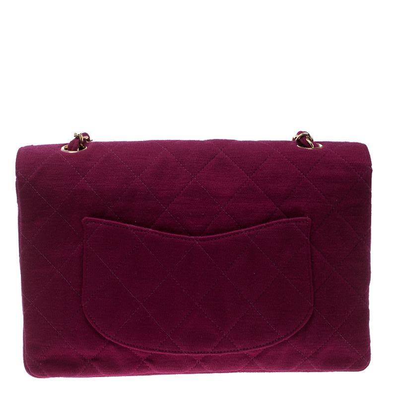 Chanel's Flap bags are the most iconic handbags. The classic single flap bag is crafted from magenta jersey and features the iconic quilted pattern. It has a chain and jersey woven strap along with a CC twist lock closure in gold tone. The flap