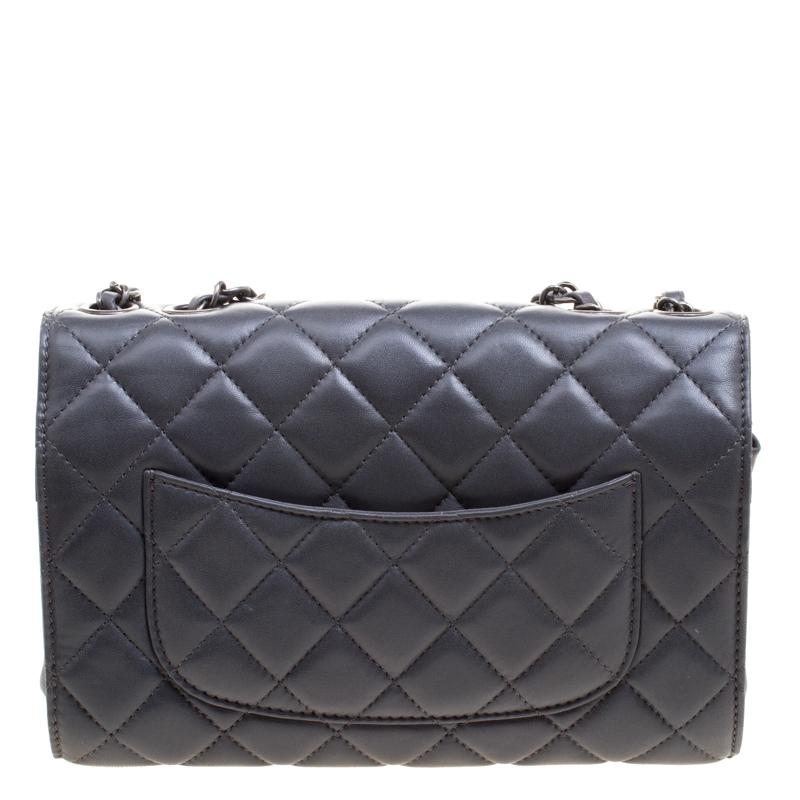 Light up your outfit with this glamorous Classic flap shoulder bag from Chanel. The bag is crafted from grey leather and features the iconic quilted pattern. The front flap has the classic CC lock closure that opens to a satin lined interior and the