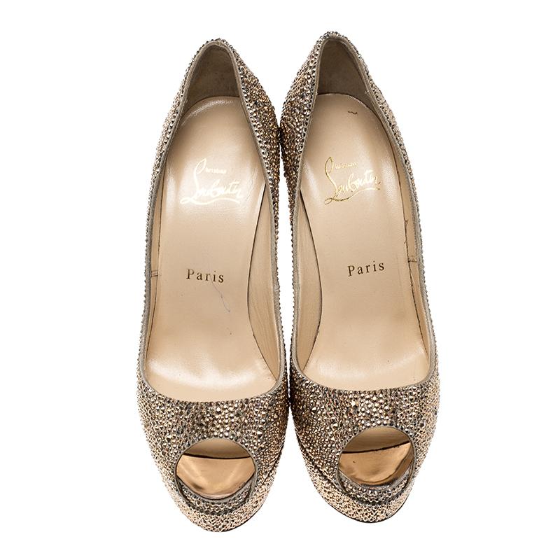 Make heads turn with this gorgeous pair of Louboutins that exude high fashion. This piece from their Lady Peep collection features gold crystals embellished on the exterior. Peep toe in style they come with the signature red sole, leather lined