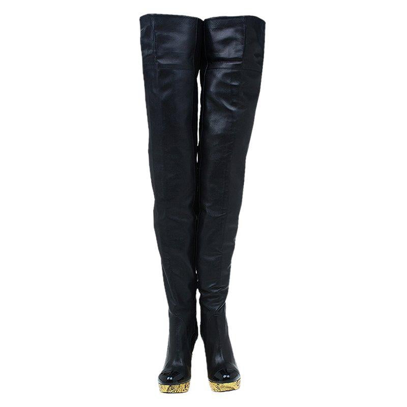 To complement your upbeat style, Chanel brings you these gorgeous thigh high boots that come flowing with high-fashion. It is made from black leather and designed with cutouts, and metallic gold brocade wedges. Pair them with oversized sweaters and
