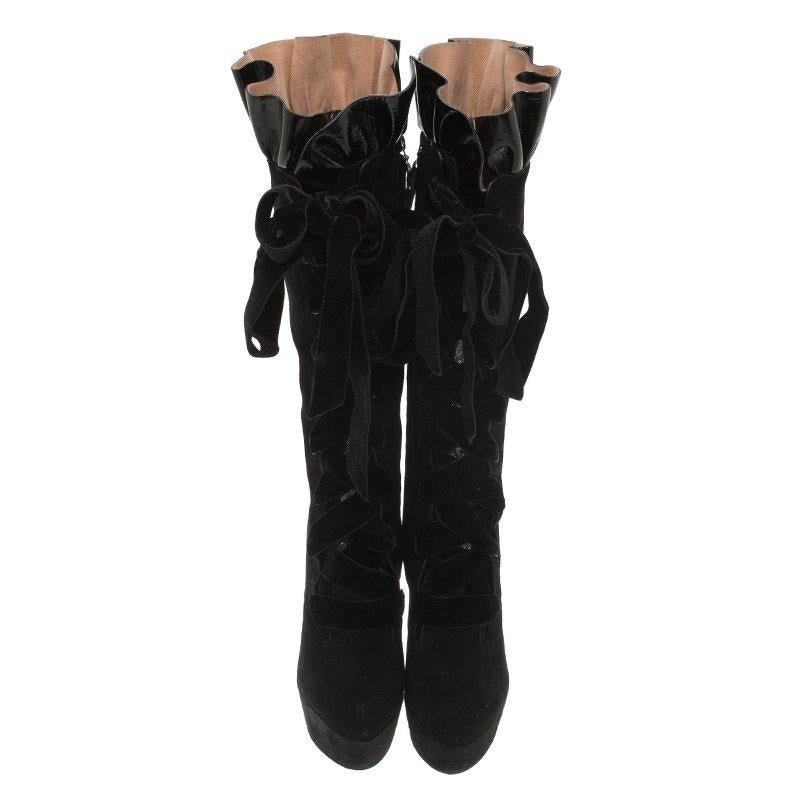 This pair of Cancan lace up knee boots coming from Louis Vuitton will offer a captivating and cool look to your personality. It is crafted from black suede and is adorned with stunning velvet lace up design, and an adorable ruffled top with patent
