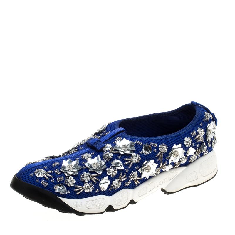 These Dior Fusion slip-on sneakers styled with a blue mesh exterior will keep you comfortable with a feminine glam style. Featuring beautiful floral embellishments all through the surface, these shoes are complete with rubber soles that are detailed