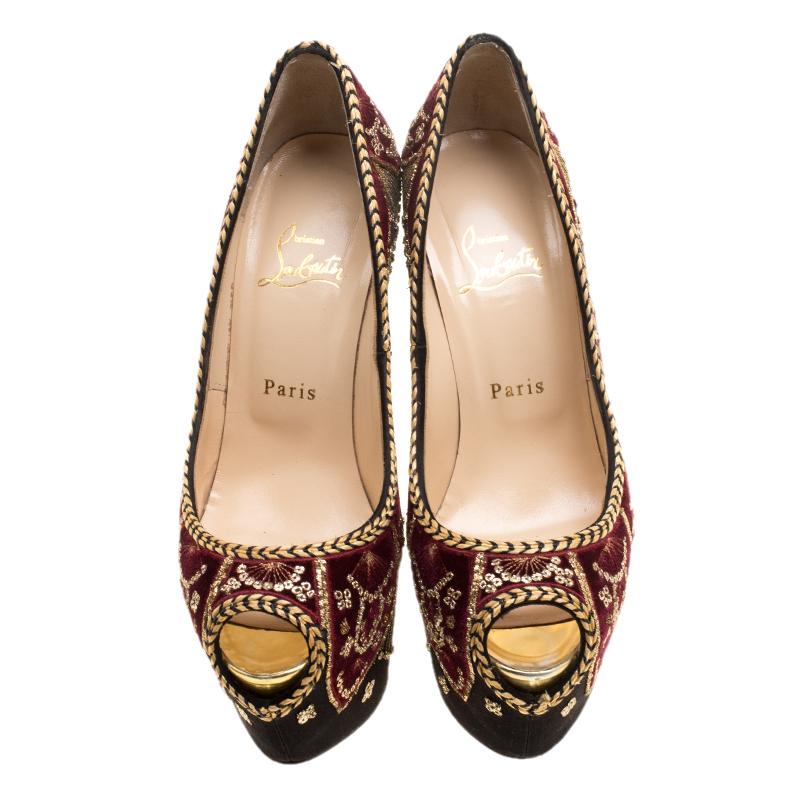 One can only expect such lavish footwear designs from Christian Louboutin as this Highness Sombrero platform pumps. Rendered in black satin, the pair is gloriously beautified with gold-tone embroidery detailed over velvet panels, blending