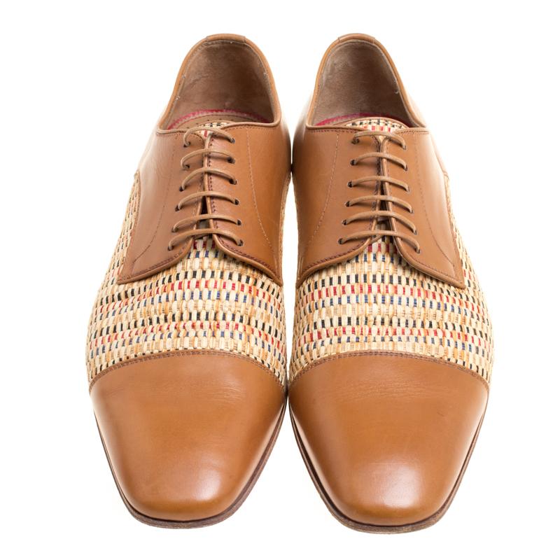 Characterised by the quirky woven straw design on the uppers; this pair of derby shoes from the house of Christian Louboutin have been crafted with the utmost care to reflect a dapper look. Constructed using brown leather that imparts a classy