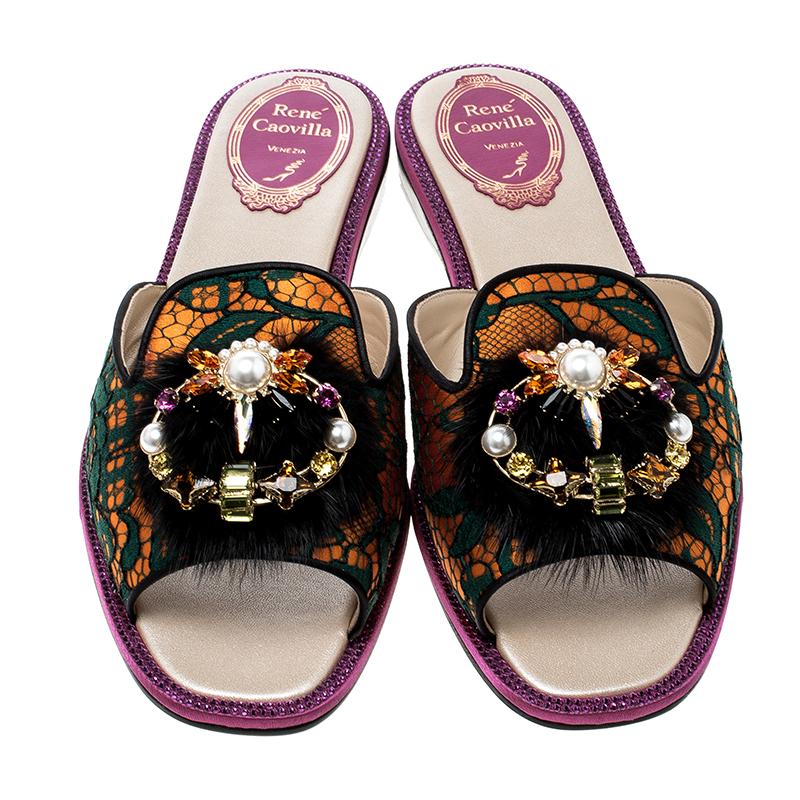For days you don't want to wear heels, go for these Rene Caovilla flat slides. Brilliantly crafted from a multicolor lace and mink body, this pair comes with a wide frontal strap with side cut-outs and heavily embellished with crystal at the top.