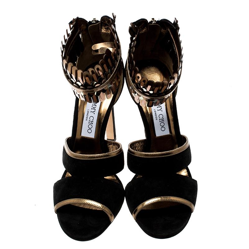 You'll truly be in utter love with these sandals from Jimmy Choo as they are stylish and modern. They've been designed using suede and mirrored leather with decorative ankle cuffs and zippers on the counters. The sandals are balanced on 11.5