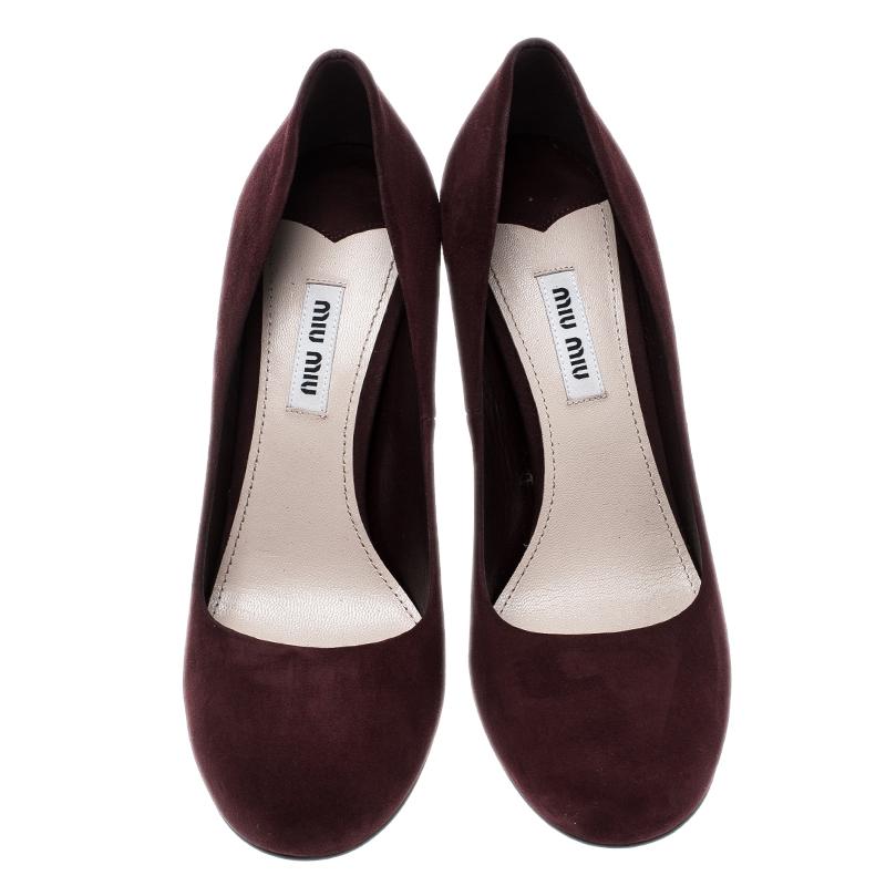 These pumps from Miu Miu will charm you and lift your style with elegance. Covered in burgundy suede, they feature round toes, and 10.5 cm block heels that are embellished with crystals.

Includes: Original Dustbag
