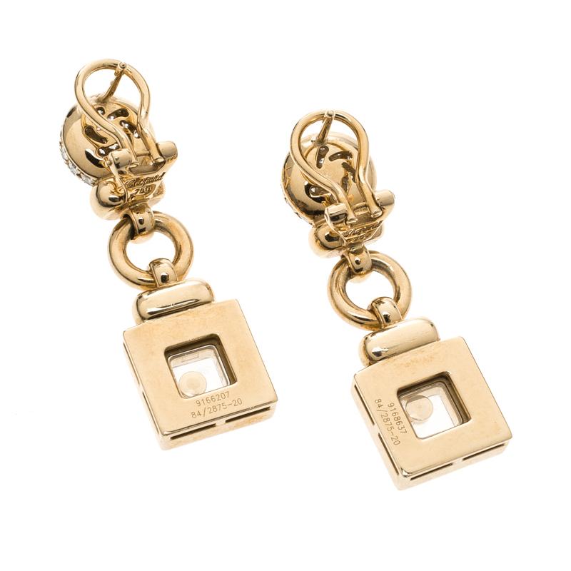 These earrings are accented by approximately 176 round brilliant cut diamonds, weighing approximately a carat. The earring has pave set diamonds and has a floating diamond each between sapphire crystal glass. A simple yet gorgeous accessory to give