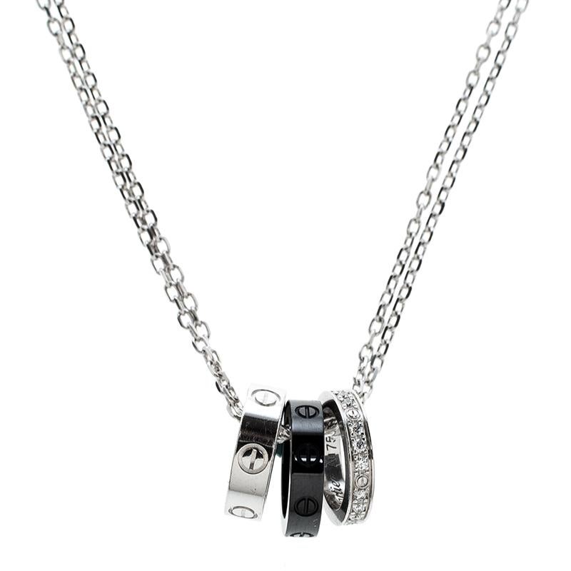 Part of the 'Love' collection from Cartier, this necklace is a must-have for any Cartier fan. It features an 18k white gold chain centred with three Cartier band rings with diamonds embedded on it. It comes with a lobster clasp closure that can