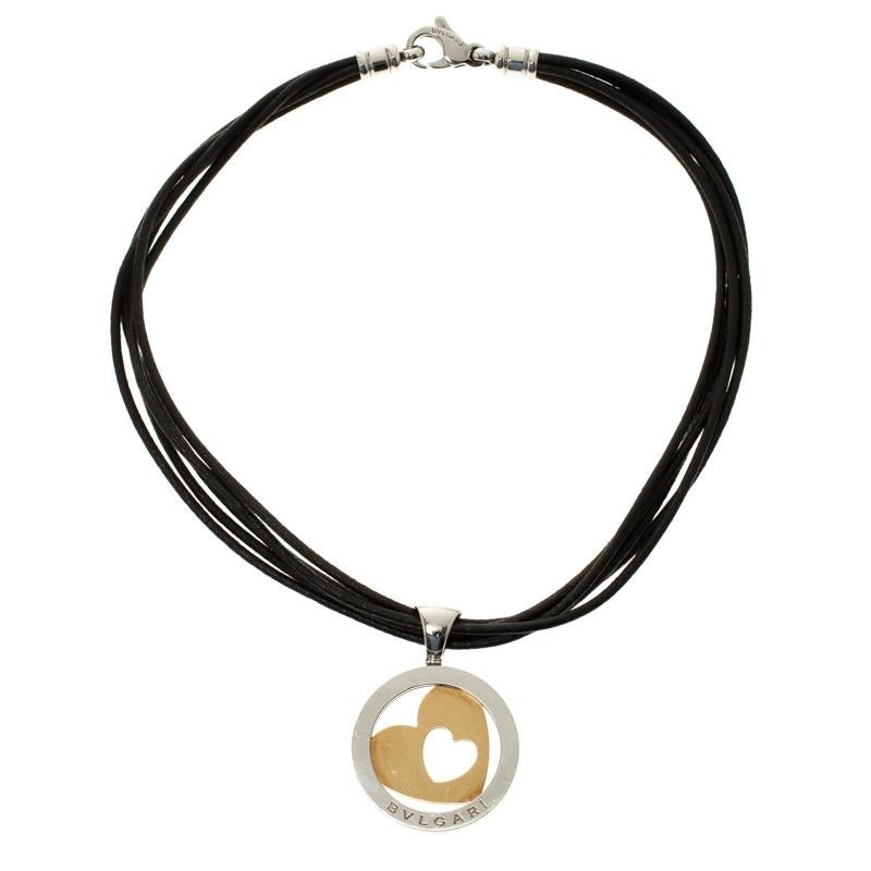 Bvlgari's necklace is effortless, bold and stylish. It features strands of leather cords secured with a lobster clasp closure and centred with a cutesy rounded motif with heart-shaped cut-out pendant crafted in 18k gold and stainless steel. Style