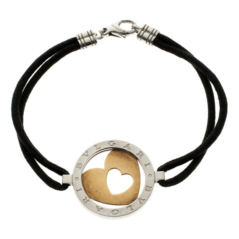 Bvlgari Tondo bracelet is designed with layers of cords and centred with a rounded motif. It features an 18k yellow gold and stainless steel body with a heart-shaped cut-out. This bracelet is secured with a lobster clasp closure. A perfect accessory