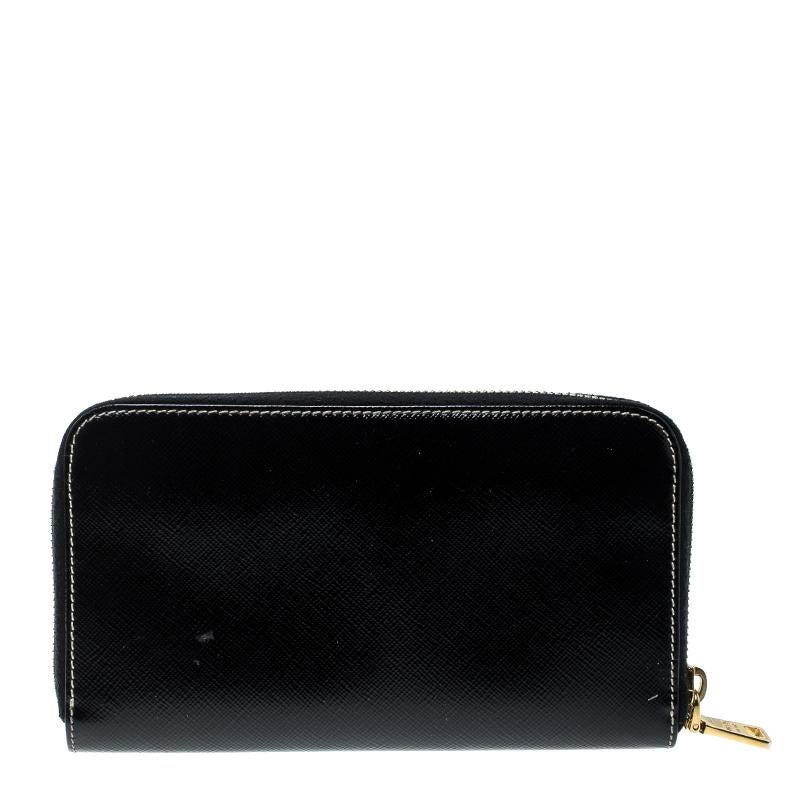 Combining class and functionality, this creation from Prada is crafted from black Saffiano leather. The zip around wallet opens to a leather and fabric interior and features multiple card slots, two open compartments divided by a zipped coin pocket.