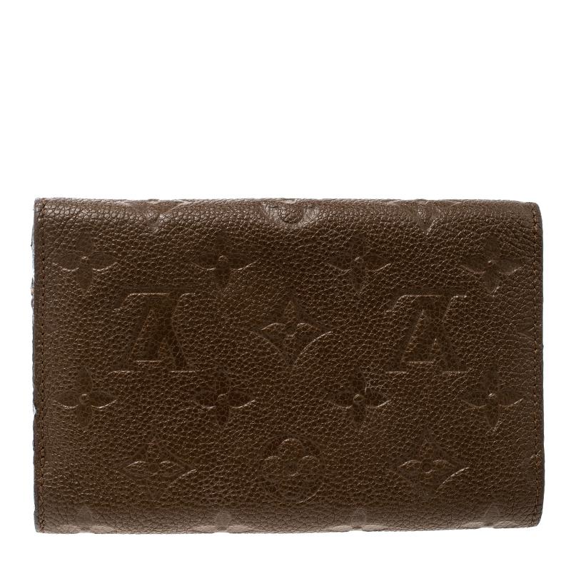 How fine is this wallet from Louis Vuitton! Crafted from Monogram Empreinte leather and designed as a tri-fold with an envelope flap, the wallet offers luxury and utility. A snap button conveniently secures a zip pocket and multiple slots for your