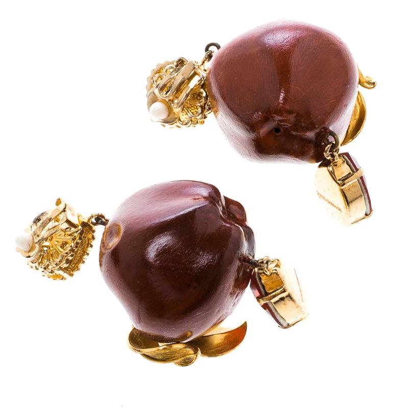 These earrings from Dolce&Gabbana are unbelievably beautiful. They are so well crafted from gold-tone metal and styled with red apples that have gold-tone leaves and sparkly red crystals. They are complete with clip-ons.

Includes: Authenticity