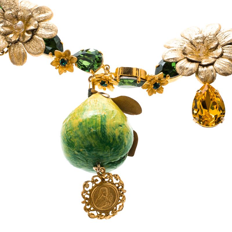 Designs by Dolce&Gabbana are not only well-made but are loaded with wonder and sweetness. This necklace, for example, is so unbelievably pretty. Made from gold-tone metal, the neckpiece has sparkling crystals, flowers and dangling fig fruits. All