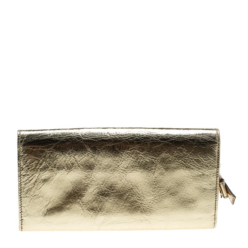 This lovely wallet from Dolce&Gabbana will surely delight your impeccable style. It has been crafted from gold mirror leather and designed with a heart on the flap that reads the label. The wallet is complete with multiple slots and a zip