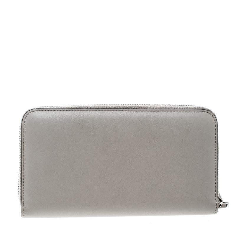 How lovely is this Fendi wallet! Every accent on it is appealing and high in style, like the Monster eye detailing on the grey leather exterior and the zip around that reveals multiple slots and a zip compartment.

Includes: Original Dustbag


