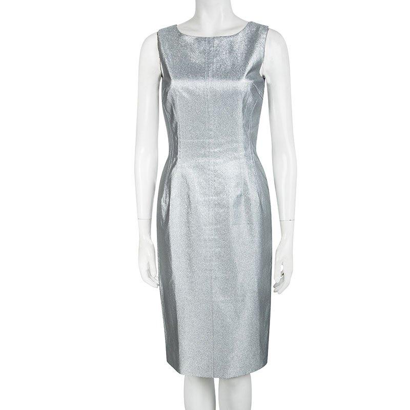 One glance and you'll fall in love with this shimmering silver dress from Dolce and Gabbana. The sheath dress is made of a cotton blend and features a simple structured silhouette. It flaunts a round neckline, subtle pleats at the sides and a long