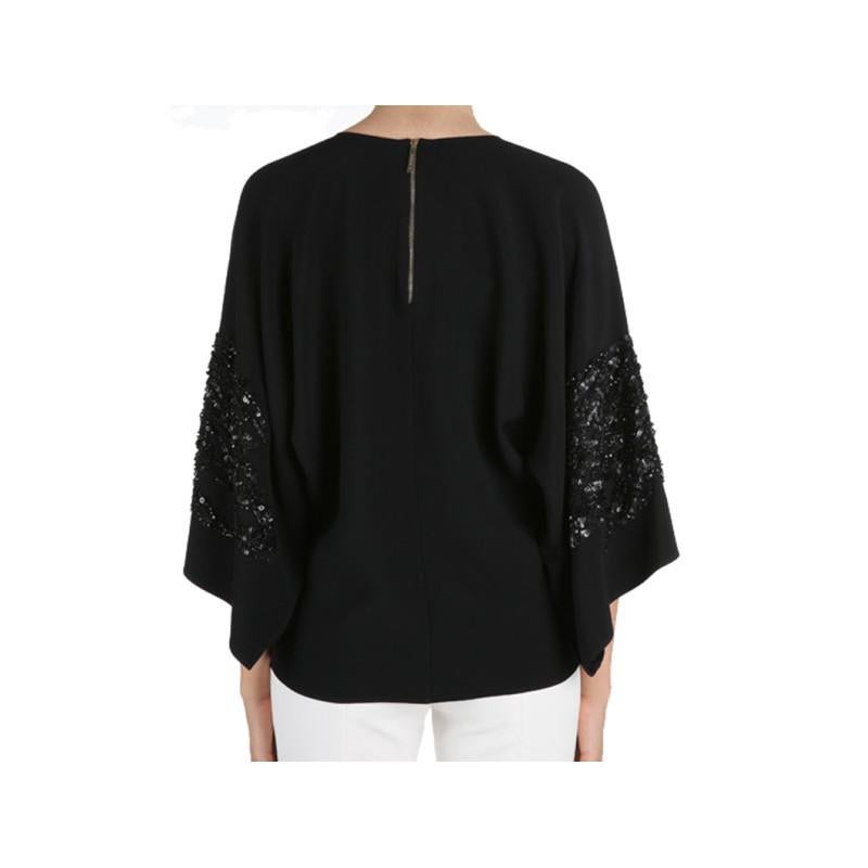 Whether worn to a morning brunch or an evening dinner, this Elie Saab AW14 top will leave you at the top of the social ladder. Its classic black color is designed with a round neckline and wide sleeves embellished with black sequins. This top
