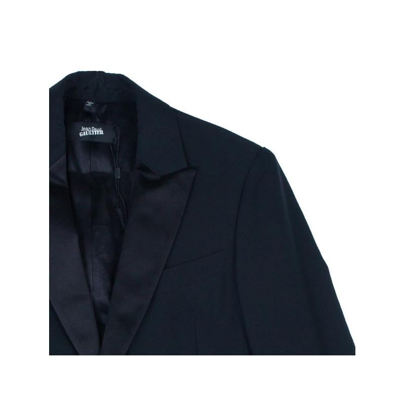 Add a smart touch to your outfit with this Jean Paul Gaultier blue tuxedo woven jacket. This jacket features a lined collar, long sleeves, and a button down closure. This jacket is also lined with matching black colored cupro.

Includes: Price Tag,