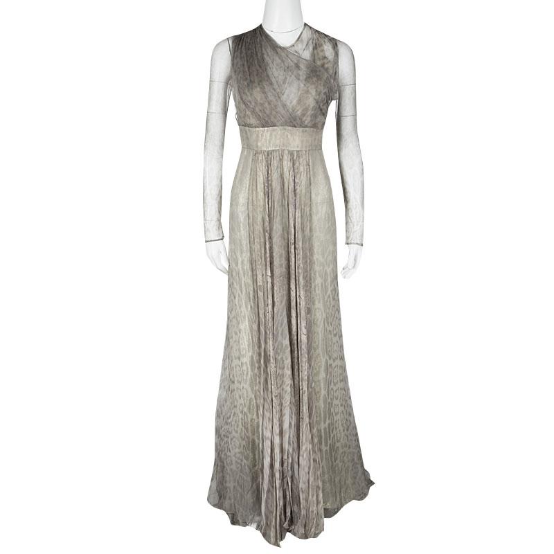 Masterfully tailored in silk, this Roberto Cavalli gown features a subtle grey animal print all over. Detailed with tulle drape, this floor-sweeping gown comes with long sheer sleeves, a flap-over neckline, a rear cut-out and a banded waistline that