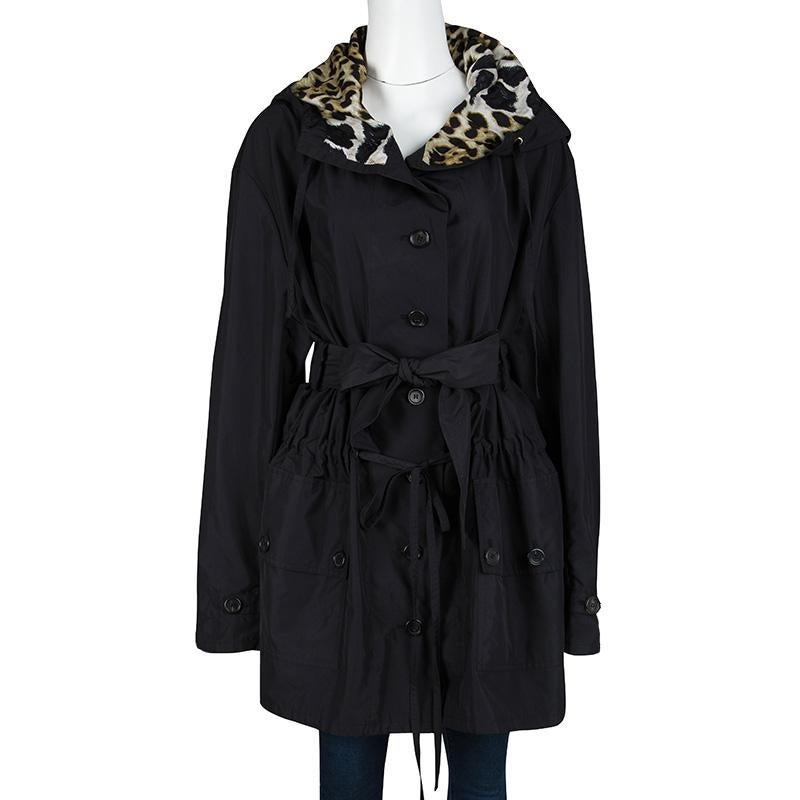 A classic black trench coat is made to look more stylish and glamorous here by the fashion house Yves Saint Laurent Paris. Constructed in black fabric, this coat features a buttoned closure at the front with a belt at the waist and a tie detail to