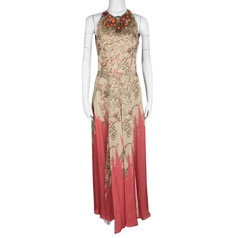 Look elegant and charming each time you step out wearing this beautiful Matthew Williamson maxi dress. Constructed in a multicoloured floral printed silk fabric, this dress features red and orange bead and stone embellishments along the neckline of