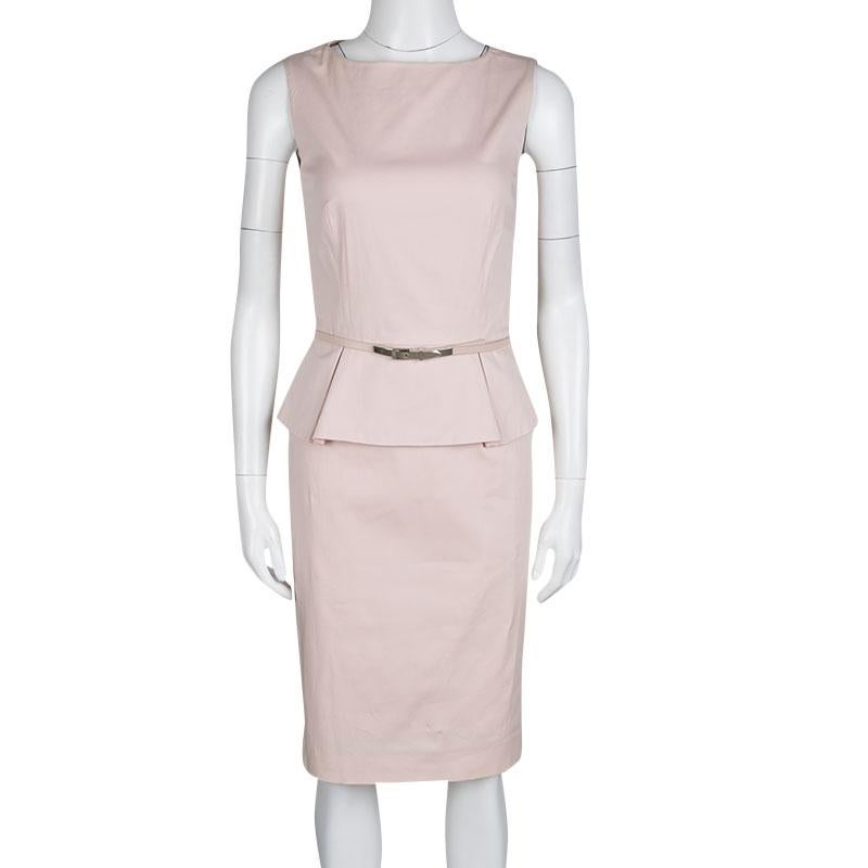Own this chic dress, perfect for any formal event. It is an example of Dior's artful thoughts put together with sophisticated design. Flaunting a blushed pink hue, the dress is shaped in peplum style that highlights the waistline along with a