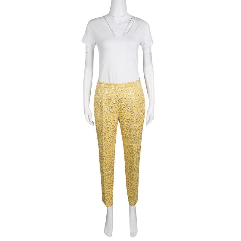 Cut from a silk blend with jacquard effect, these Dolce and Gabbana pants are a testament to the label's love for fine artistry and its Italian spirit. Floral lurex detail adorned these yellow pants that are ideal for a crisp evening look. They are