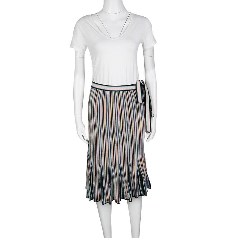 Missoni's wrap skirt is crafted with a blend of supreme fabrics that grants a soothing tactile finish to the piece. It features a wrap-tie around the waist and is adorned with multicolored vertical stripes all over. The hemline is pleated creating a