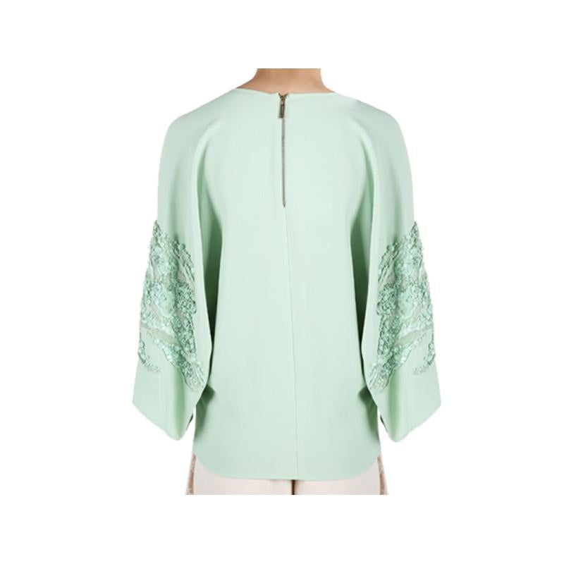 Whether worn to a morning brunch or an evening dinner, this Elie Saab AW14 top will leave you at the top of the social ladder. Its bright mint shade is designed with a round neckline and wide sleeves embellished with matching sequins. This top