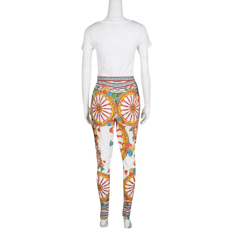 Dolce and Gabbana are known for clothes that exude strong feminity and charm. These pants feature the famous scillain print in eye-catching multicolor hues. Cut to a slim silhouette, they can be teamed up with a tank top to look casually