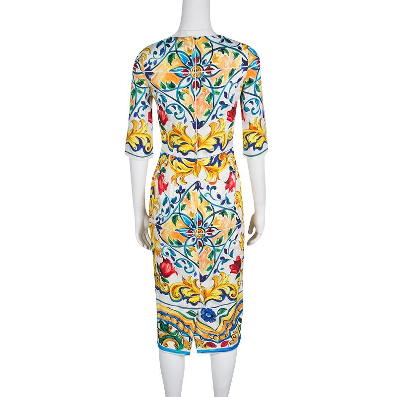 To infuse a groovy style into your elegant formal looks, pick this sheath dress from Dolce and Gabbana. It features a silk body with hints of stretch detailed with multicolored Majolica prints. Short sleeves, concealed zip closure at the rear, and