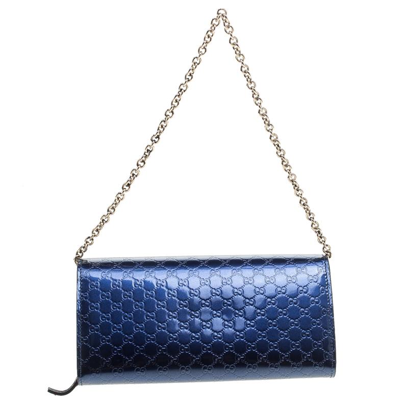 Gucci the mega fashion house brings you yet another gorgeous accessory with this wallet. It has been crafted from blue patent leather and styled with their microguccissima pattern. The front flap adorns a bow and opens to reveal a well-sized
