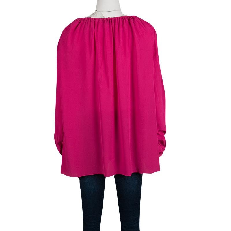 Saint Laurent Paris's blouse in bright pink hue exudes feminity and style in equal measure. It is made of 100% silk that gives it a smooth finish. It comes with tassel tie detail at the neckline and long, comfortable sleeves. Pair yours with fitted