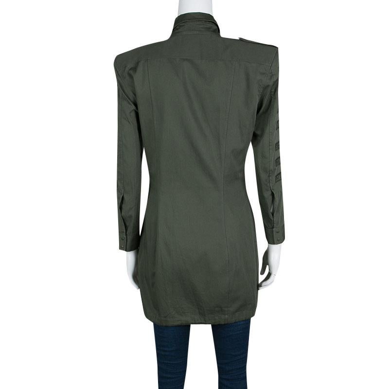 Trendy and chic, this Military shirt tunic by Balmain is one creation that will brighten your day. Luxuriously made from lightweight cotton, this piece is accentuated with long sleeves, collared neck, and embroidery on the sleeves. Front button