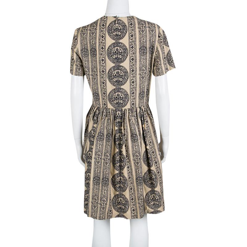 Feminine and stylish, this 100% cotton dress is a must-have masterpiece in any fashionista's collection. Make a top style-statement with this elegant piece from the house of Valentino. This beige outfit is perfect for casual occasions and is secured