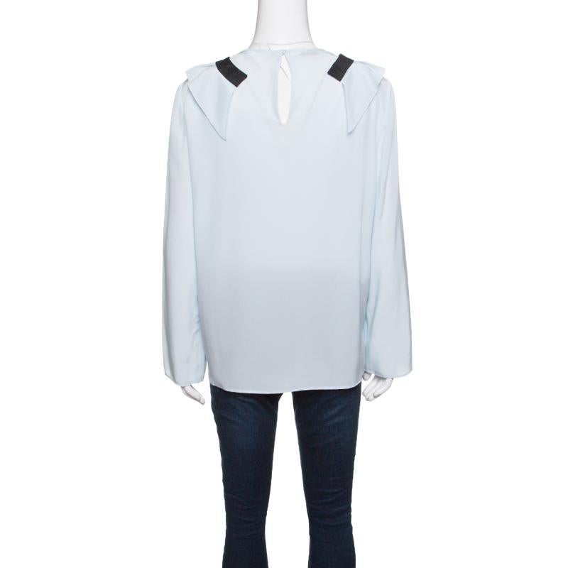 Don a minimalist style with this blouse from the house of Miu Miu. Designed in a simple structure with ruffle details on the front and contrasting trims, the top, crafted in silk, carries a breezy sky blue hue. It will look good when tucked into
