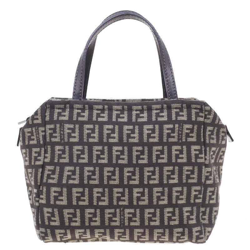 Keep it simple with this Fendi Zuccino Satchel. The monogrammed canvas exterior is combined with leather handles giving this bag an elegant touch. The zip enclosed fabric interior includes a patch pocket. Stylish and chic, it will become your