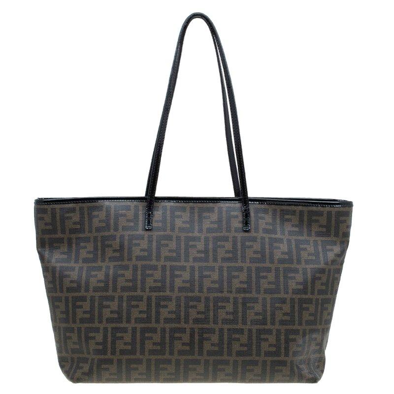 This tote from Fendi is the perfect size for shopping trips. A logo-jacquard canvas makes this distinctively Fendi, and the print of the clutch on the tote is a humorous touch. A red lined interior has a zip pocket and closes with a zip.

Includes: