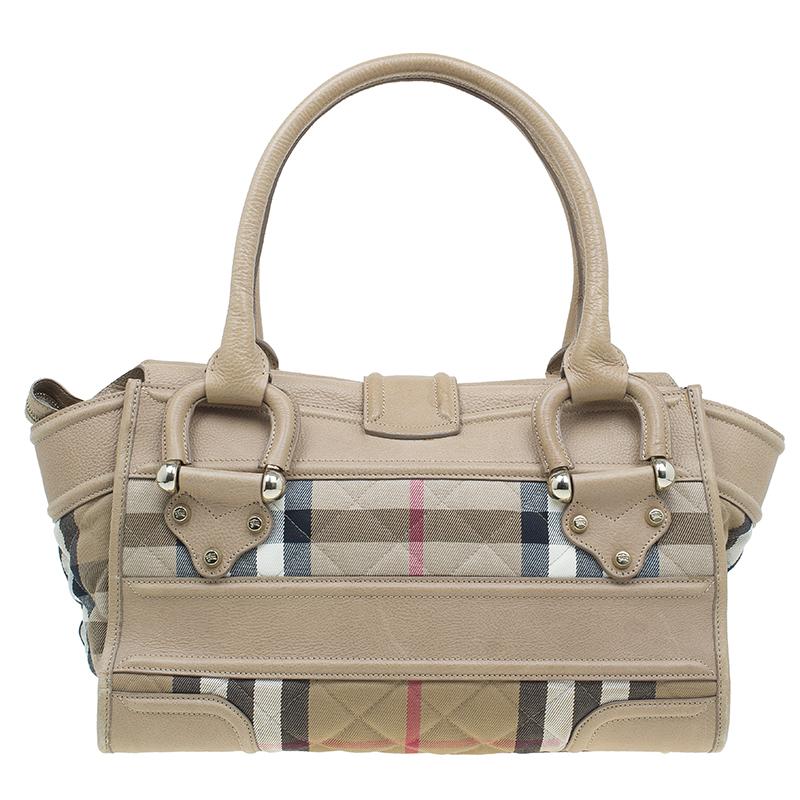 This Burberry quilted House Check Manor Satchel is a timeless handbag that you will love for years to come. This creation is made from leather, in Burberry’s well-known check pattern, and with smooth cream leather trim. The sturdy rolled leather
