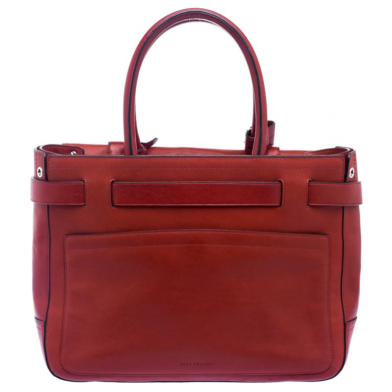 This Reed Krakoff Boxer tote is crafted from red leather and features belt detailing at the front. It is equipped with dual rolled handles and a leather tag. The fabric lined interior has enough space to hold all your daily essentials.

Includes: