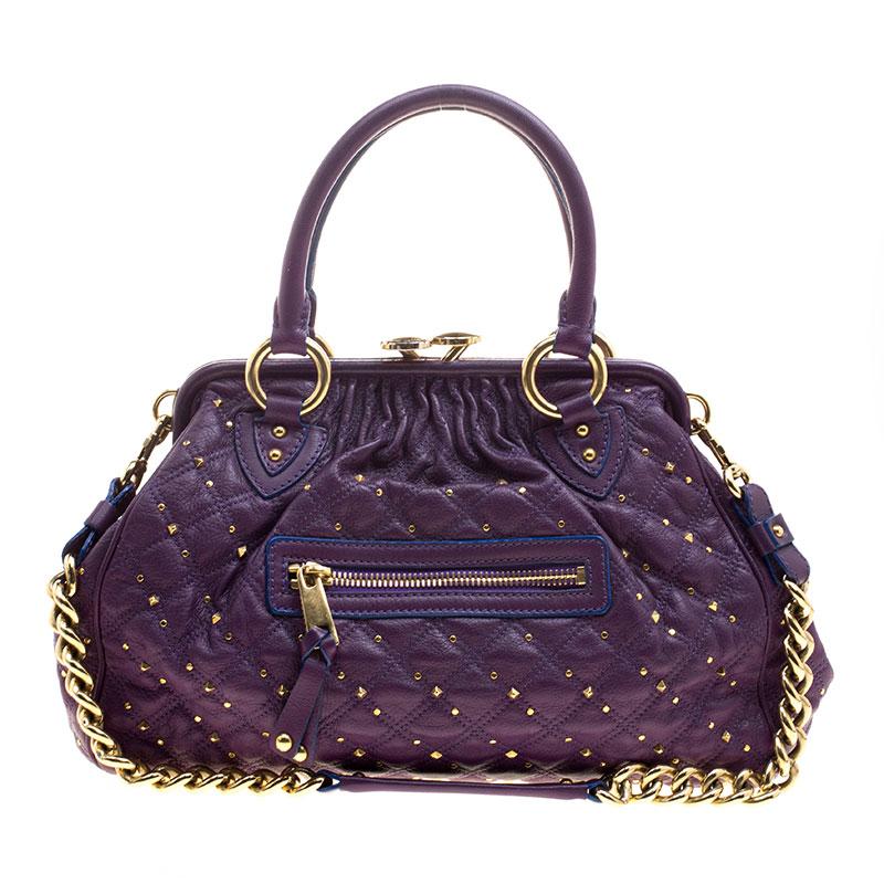 This Marc Jacobs design has a purple quilted exterior crafted from leather and gold-tone hardware. The elegant Stam bag features a kiss-lock top closure that opens to a fabric interior, a front zipper, dual handles and a shoulder chain. Swing this