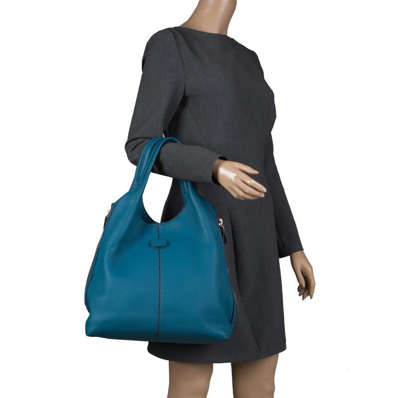 This elegant tote from Tod's is crafted from teal-blue pebbled leather. It features dual top handles and side zips to expand the bag. It is equipped with a spacious satin lined interior that will hold all your essentials safely.




Includes: The
