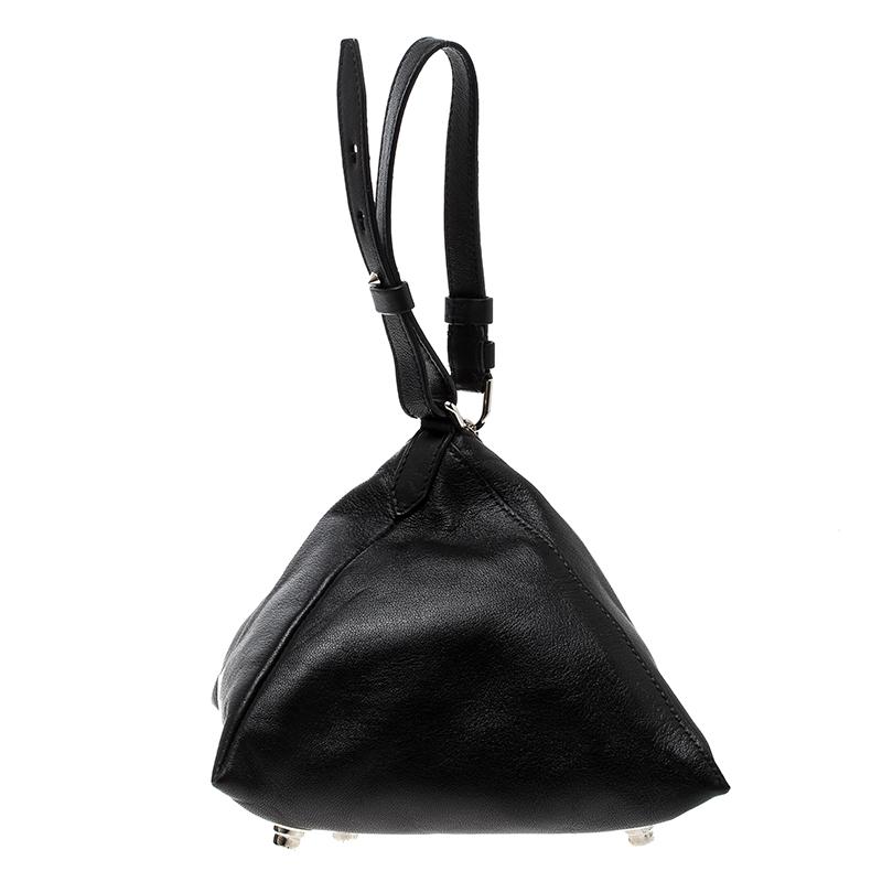 Made of leather, this black pouch from the house of Givenchy is a creation worthy of being yours. It is designed as a triangle with a zip closure, leather interior, wristlets and studs on the bottom. The pouch is well-made and right on